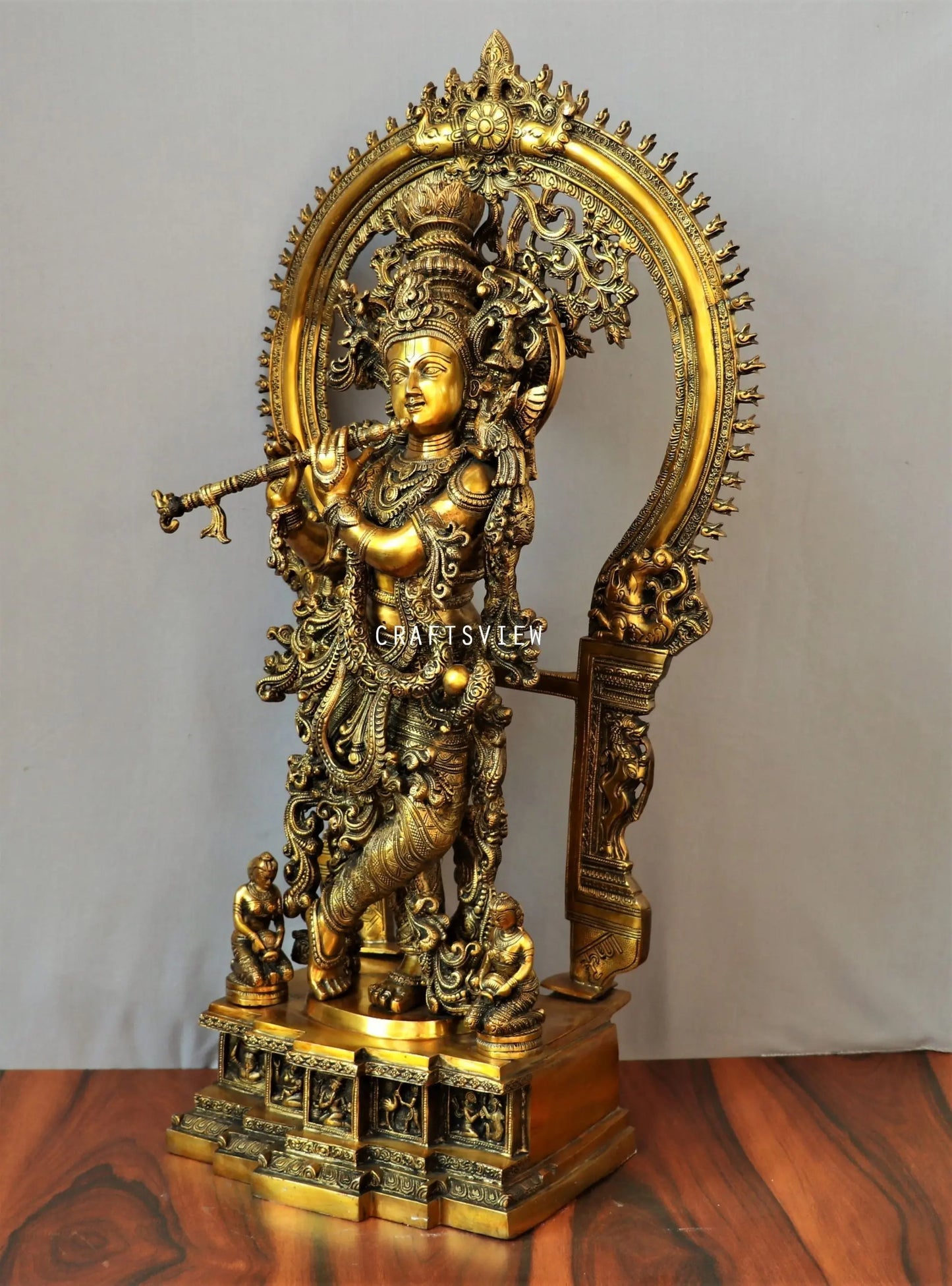 Lord Krishna stands on an engraved base with Frame 32" craftsview