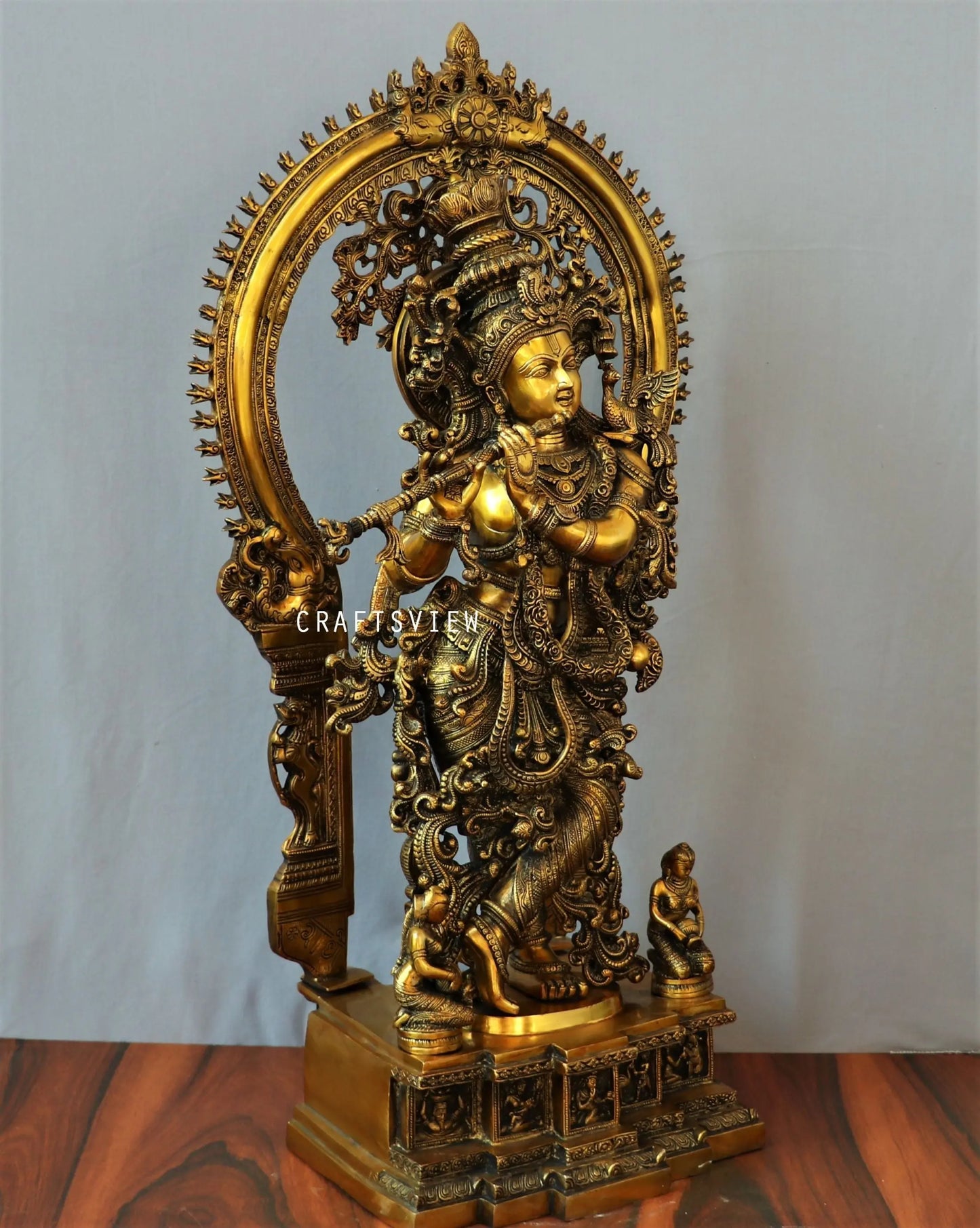 Lord Krishna stands on an engraved base with Frame 32" craftsview