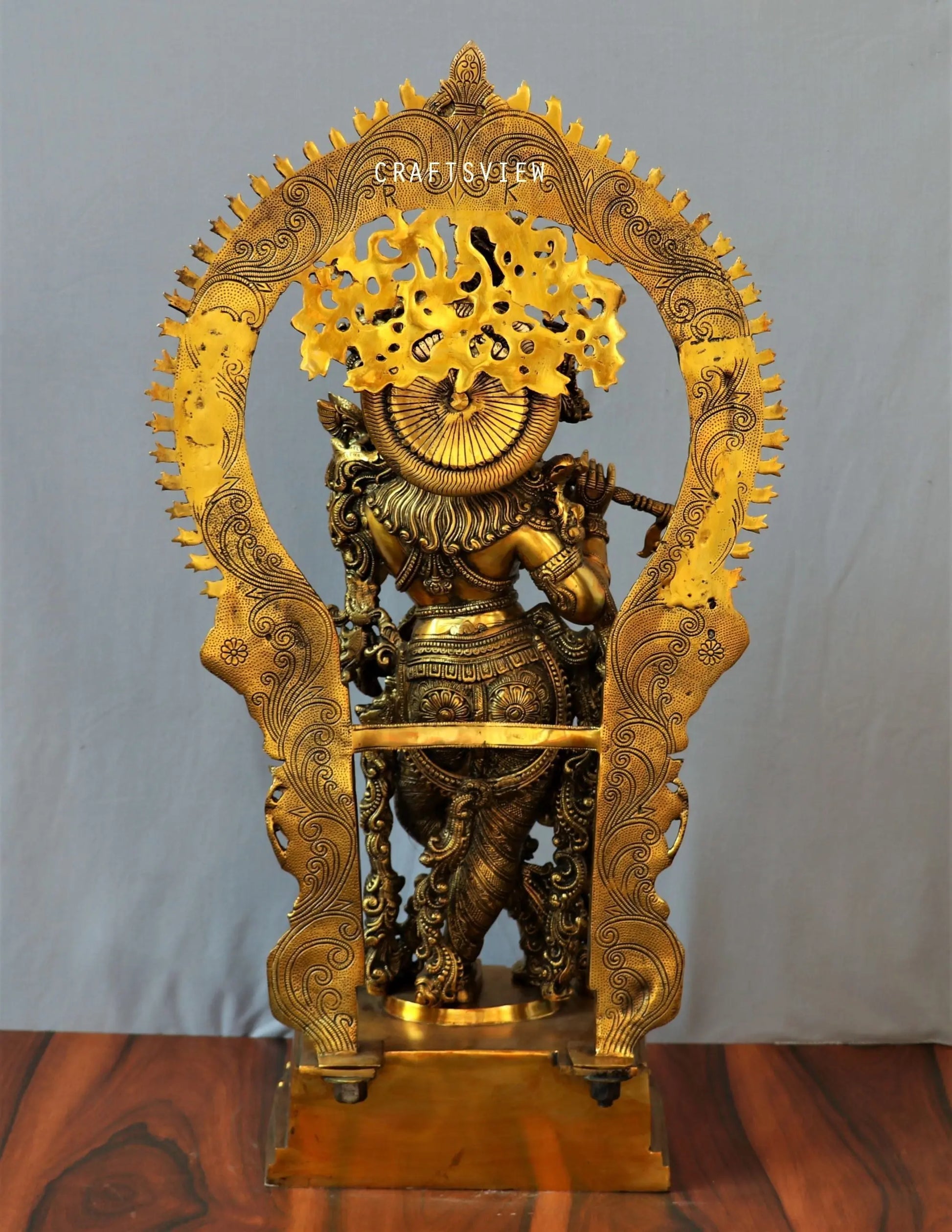 Lord Krishna stands on an engraved base with Frame 32" craftsview